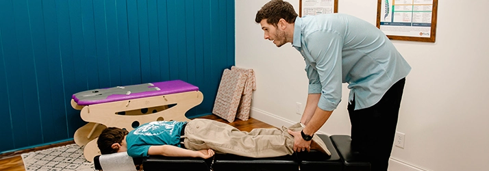 Pediatric Chiropractor Max Carlin Examining Pediatric Patient