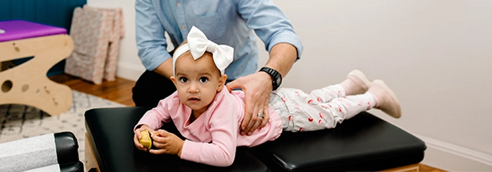 Pediatric Chiropractor Max Carlin Examining Young Patient