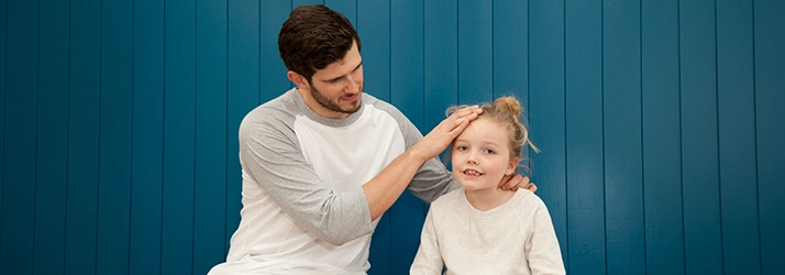 Pediatric Chiropractor Max Carlin Feeling A Patient's Forehead
