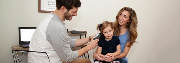 Pediatric Chiropractor Max Carlin Using Device On Young Patient