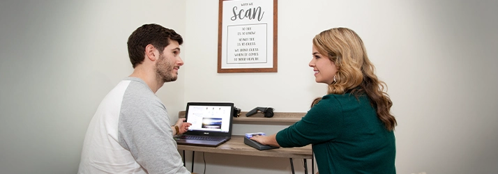 Pediatric Chiropractor Max Carlin Using Scan Device On A Patient