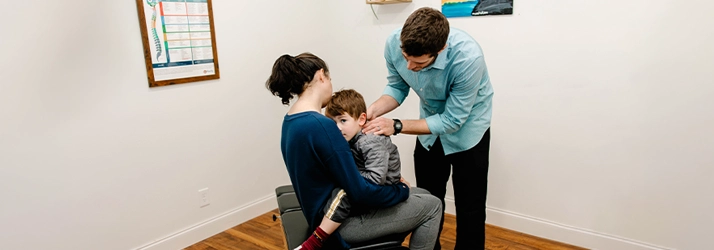 Pediatric Chiropractor Max Carlin With Anxious Young Patient