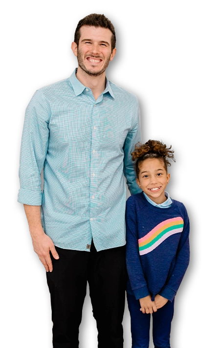 Pediatric Chiropractor Max Carlin With Happy Patient In Rainbow Sweater