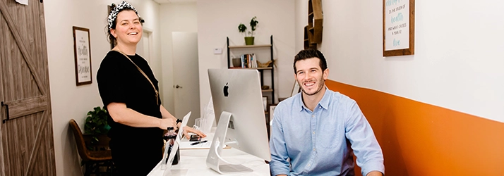 Pediatric Chiropractor Max Carlin With Patient Welcoming You To Office