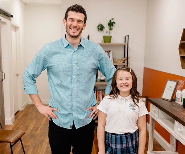 Pediatric Chiropractor Max Carlin With Smiling Young Patient