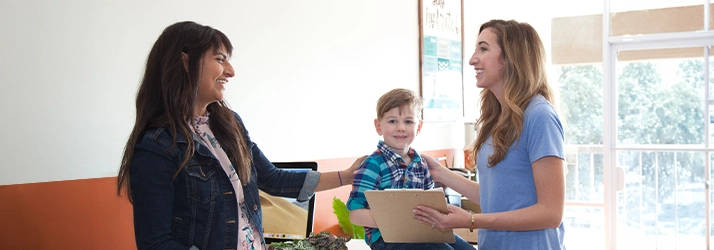 Pediatric Chiropractor Patients Checking In At Front Desk